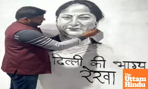 An artist creates a portrait of Delhi CM-designate Rekha Gupta
