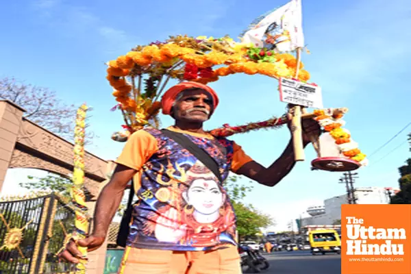 A Kanwariya carries water from the Narmada river for a ritual walk on the eve of Maha Shivratri