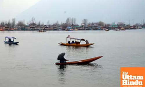 Tourists enjoy a shikara ride in the Dal Lake