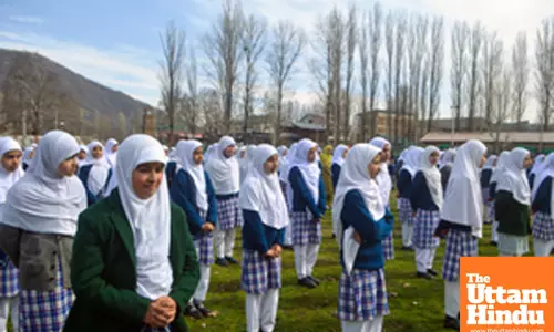 Students attend the first day of classes at Baramulla Public School after a three-month winter vacation