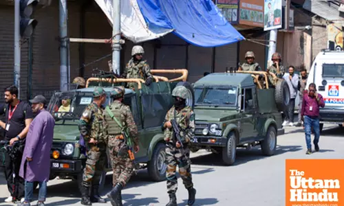 Security forces stand guard outside the Police Control Room